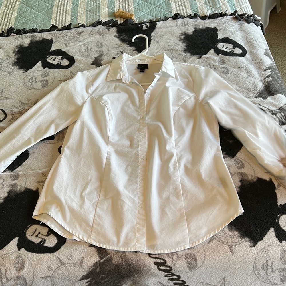 Women’s white long sleeve button down shirt.